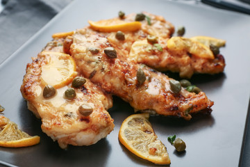 Tasty Italian chicken piccata with lemon on plate