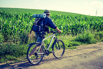 Obraz premium hipster man on a bicycle in the countryside