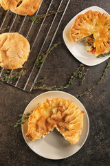 Tasty baked chicken pot pies on kitchen table