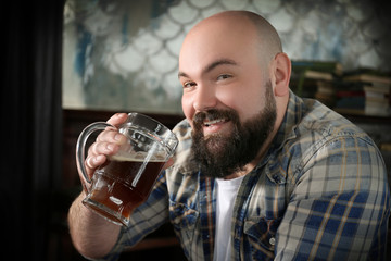 Fototapeta na wymiar Bearded man drinking beer in pub