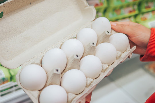 In the hands of a woman packing eggs in the supermarket
