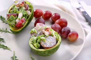 Plate with chicken salad in boats from avocado
