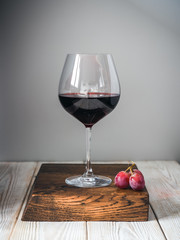 Glass of wine on wood cutting board