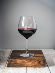 Glass of wine on wood cutting board