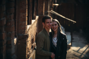 Couple has fun and laughs. kiss. Young hipster couple hugging each other in city.