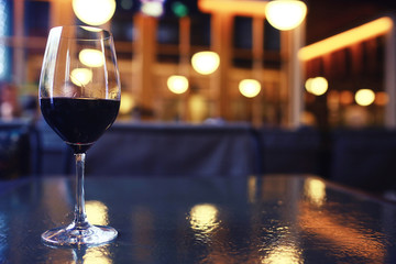 Serving a glass of red wine in a restaurant