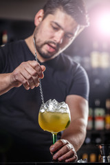 Bartender is stirring cocktail
