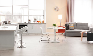 Fototapeta na wymiar Modern kitchen interior of studio apartment with white round table