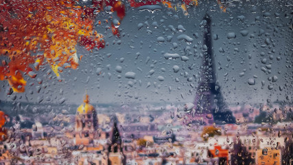 PARIS, FRANCE. A view of the city from a window from a high point during a rain. Rain drops on glass. Focus on drops
