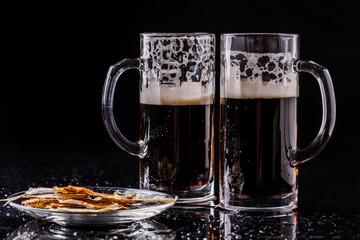 Mugs of beer with fish
