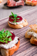 Set of bruschetta on wooden background. Crostini.