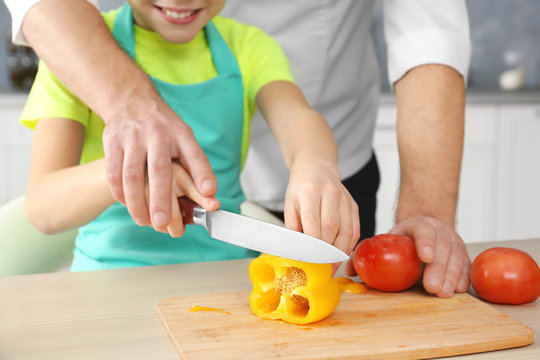 Father and son cooking together, closeup