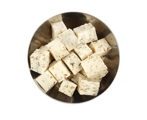 Bowl with tasty spiced cheese on white background