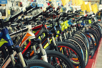 Many different bicycles indoors, closeup