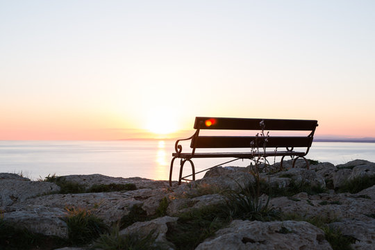 Sunset beach and bench © satura_
