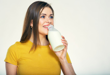 Young woman drinking milk from bottle.