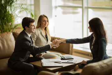Handshake of business partners after discussing a new financial contract
