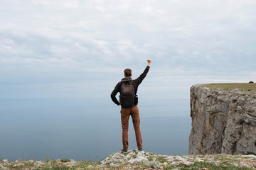 Man on top of mountain watch to the sea