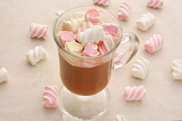 Mug of hot chocolate with marshmallows on a wooden background