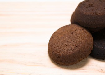 briquette used coffee grounds from espresso machine on brown wooden surface, component of soap...