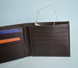 Leather wallet with credit cards and a small house. Buying a house on credit and mortgage concept