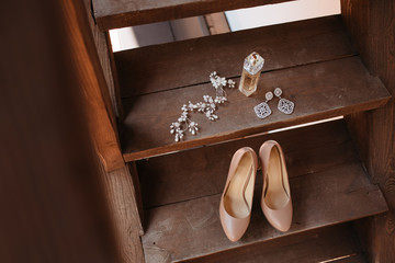 wedding attributes such as earrings, shoes, perfume, handbag