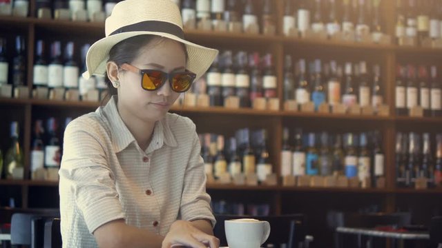 Asian woman using laptop in restaurant