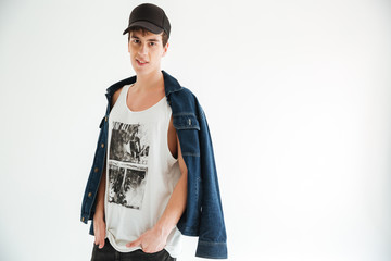 Smiling man in cap and jeans jacket looking at camera