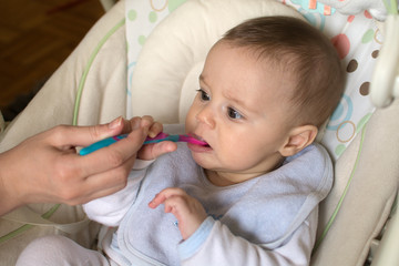 Feeding a five month old baby with a spoon 