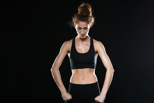 Strong fitness woman posing in studio