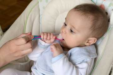 Feeding a five month old baby with a spoon
