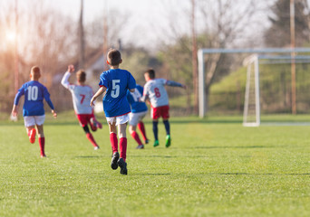 Kids soccer football - children players exercising before match on soccer field