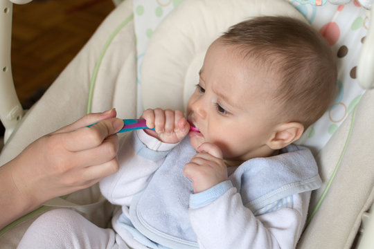 Feeding a five month old baby with a spoon 