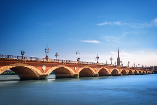 Fototapeta Pont de Pierre bridge over the Garonne river with St Michel cathedral, Bordeaux cityscape, Gironde, France