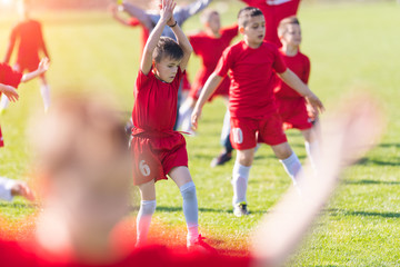 Plakat Kids soccer football - children players exercising before match on soccer field