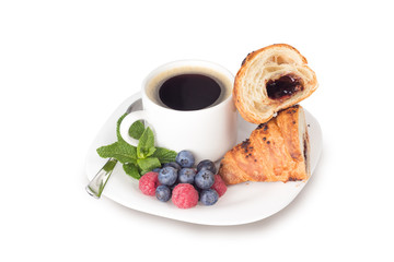 a cup of coffee and croissant isolated on white