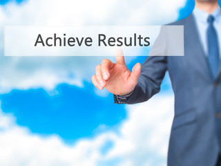 ACHIEVE RESULTS - Businessman hand pressing button on touch screen interface.