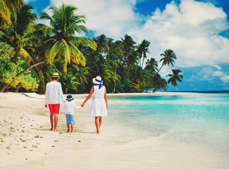 family with child walking on beach