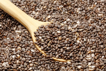 Chia seeds with a wooden spoon