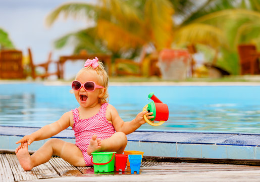 cute little girl playing on tropical beach