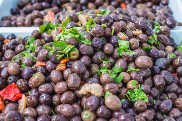 Stall with olives on market place of Ortygia isle, Syracuse city, Sicily Island in Italy