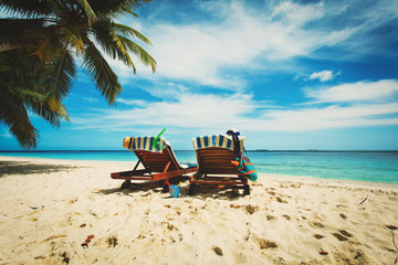 Obraz na płótnie Canvas Two beach chairs on tropical vacation