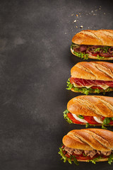Four deli sandwiches with copy space