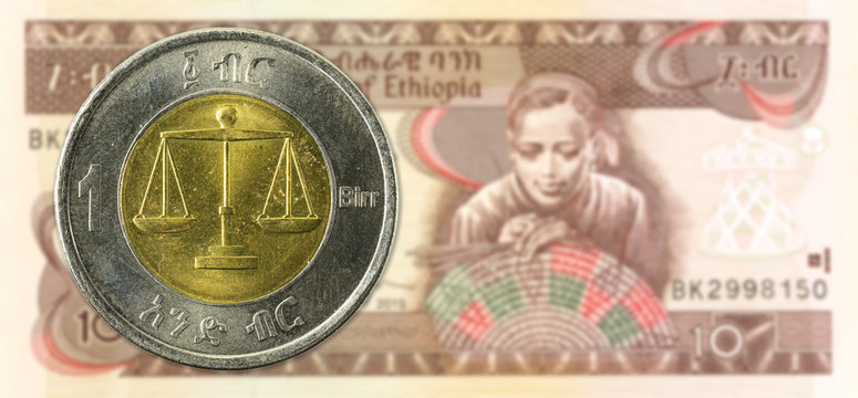 1 birr coin against 10 ethiopian birr bank note obverse - Powered by Adobe