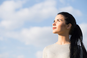 Portrait of woman in blue sky background