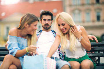 Three friends having fun on the bench