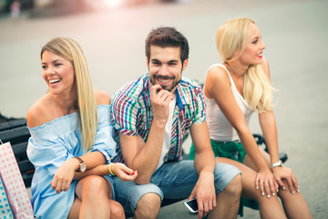 Three friends having fun on the bench
