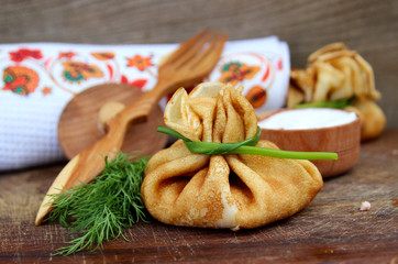 Pancakes with ham and cheese. Delicious, homemade pastries and sour cream