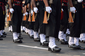A group of military are walking with assault rifle.