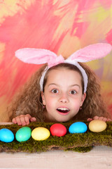 Obraz na płótnie Canvas happy easter girl in bunny ears with colorful eggs